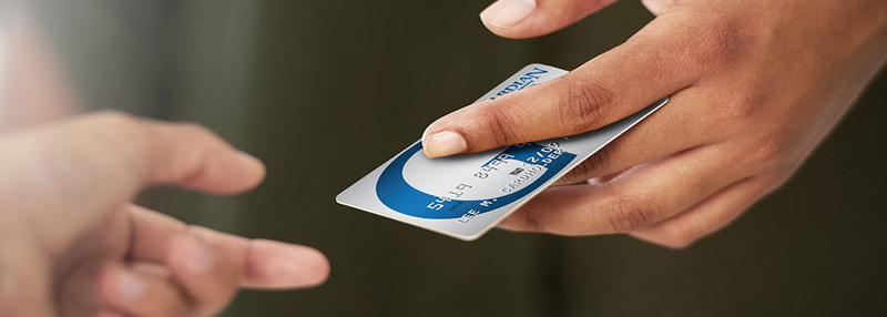 Person handing another person a Guardian Credit Card